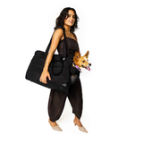 Woman holding a black Just Fred Companion Tote Dog bag with a Corgi dog on a white background