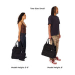 Two models holding black Just Fred Companion dog tote bags to demonstrate size, with text indicating tote size and model heights.