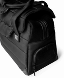 Black Just Fred Companion Tote Dog carrier showing the mesh top and side window for airflow with a visible brand logo on a white background