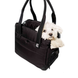 Black Just Fred Companion Tote pet carrier with a small white dog peeking out on a white background