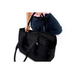 Black Just Fred Subway Tote Dog bag held by a person showing the detachable handles on a white background
