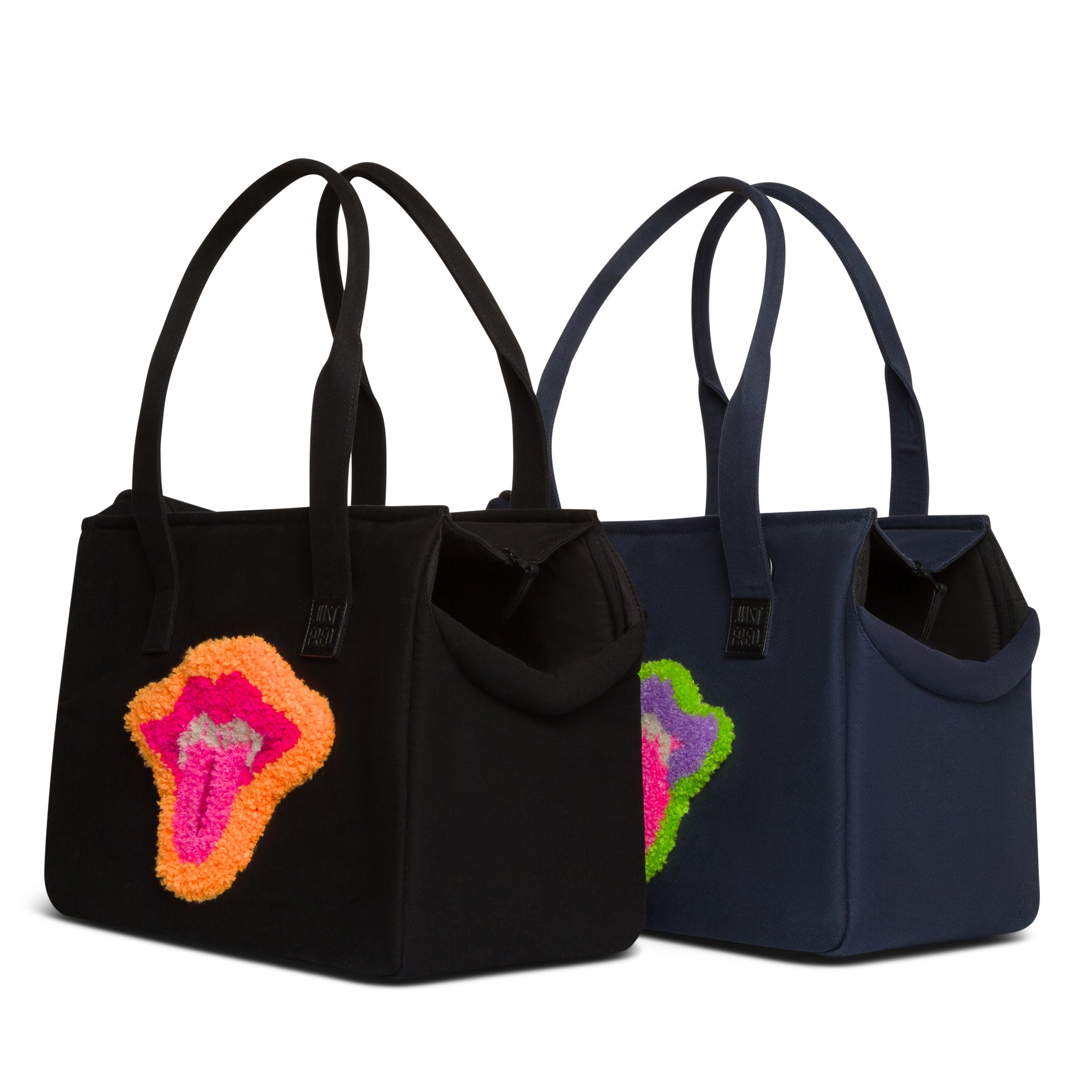 Two small Just Fred Weekend Tote dog carrier bags in navy and Black featuring lip design by Fem world by Ally Lindsay, on a white background