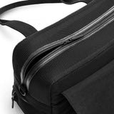 Black Just Fred Destination Tote pet dog carrier showing the top breathable mesh panel with zipped opening, on a white background 