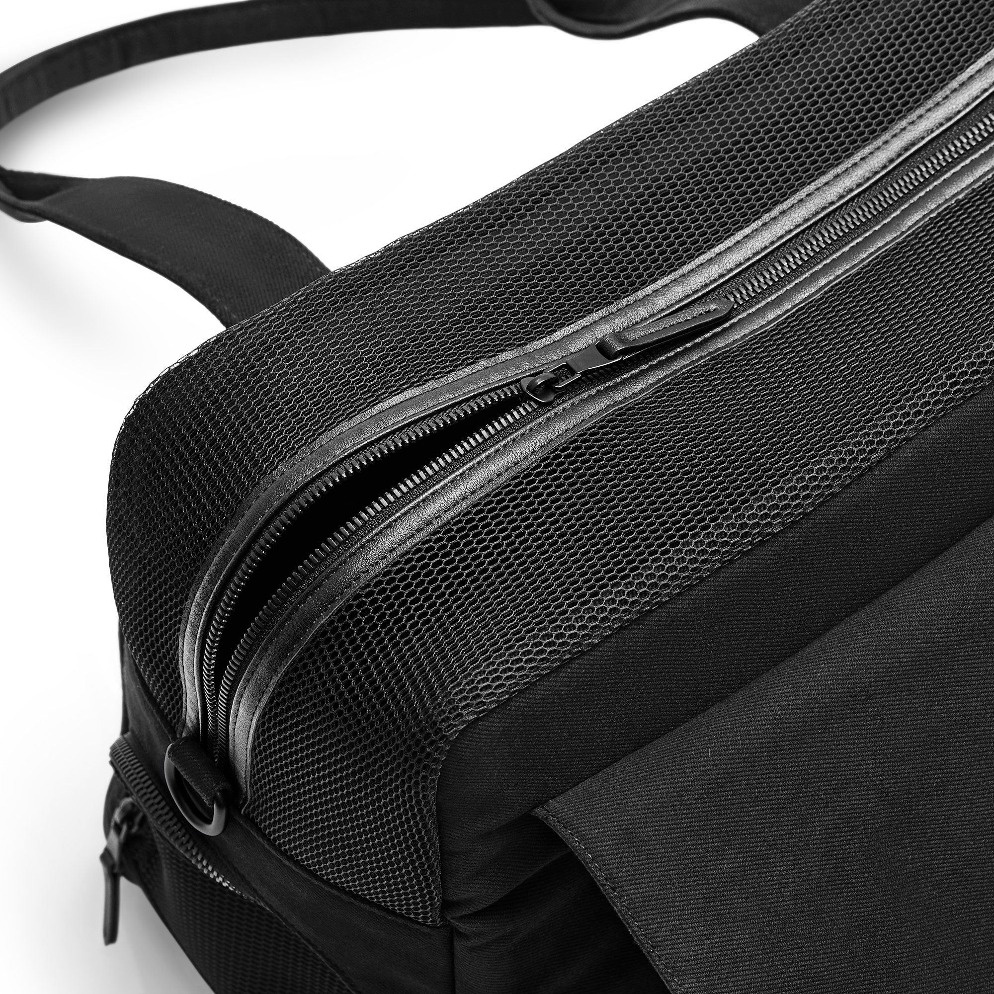 Black Just Fred Destination Tote pet dog carrier showing the top breathable mesh panel with zipped opening, on a white background 